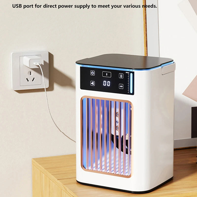 A compact white and black AeroxChill Windowless Portable AC with a digital display and vertical glowing blue-purple internal bars, shown plugged into a wall outlet on a wooden table. Text at the top says USB port for direct power supply to meet your various needs.