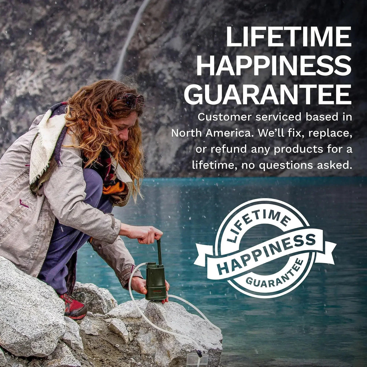 Person by a lake using a device with 'Lifetime Happiness Guarantee' text and logo.