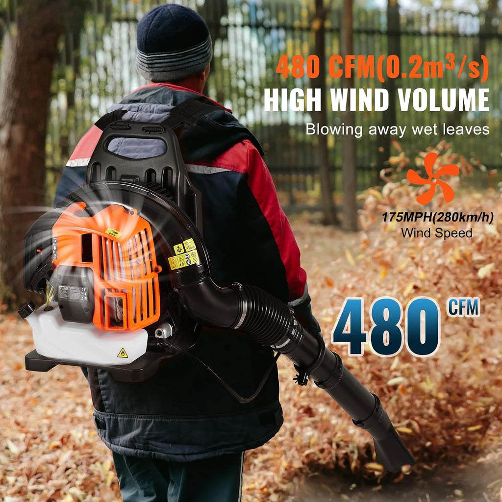 A person viewed from behind wearing a CleNolif 52CC Backpack Leaf Blower outdoors on a path covered with fallen leaves. The blower has a black body with a bright orange engine housing and a white intake area.