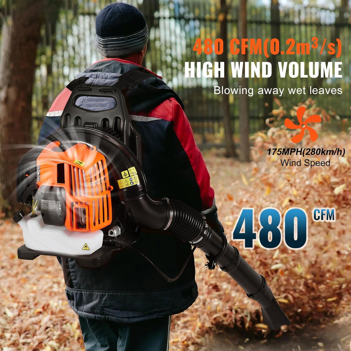 A person viewed from behind wearing a CleNolif 52CC Backpack Leaf Blower outdoors on a path covered with fallen leaves. The blower has a black body with a bright orange engine housing and a white intake area.