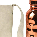 CopperSyp Copper Water Bottle with a face design on a beige pouch