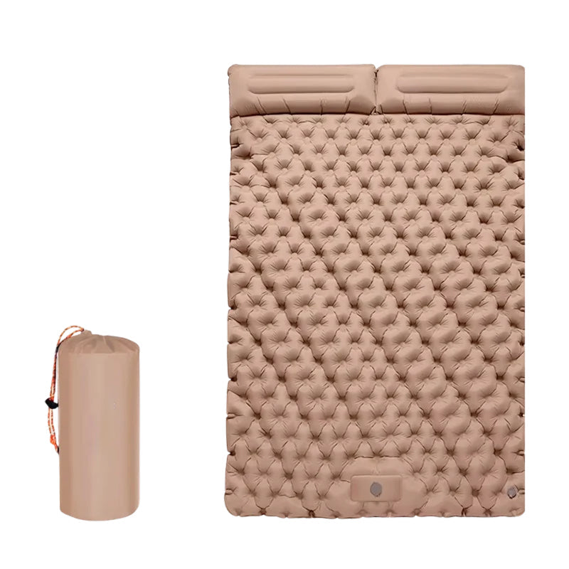 An inflatable sleeping pad shown inflated with a textured, dimpled surface, alongside its compact cylindrical carrying bag on a plain white background.