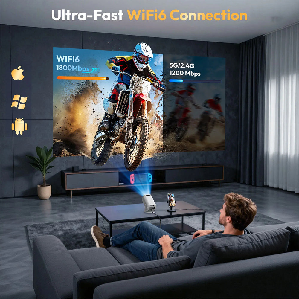 A man relaxes on a dark gray sofa in a modern living room, watching a large wall-mounted screen project a motocross scene. The room includes a coffee table, plant, curtains, and promotional text reading 'Ultra-Fast WiFi6 Connection' with speed graphics and Apple and Windows logos on the left.