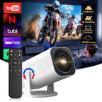 Home entertainment system with a DuskiCast Smart Projector, TV displaying a motocross video, and remote control.