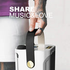 Person holding a black strap over a white portable FolbGent Karaoke Machine with 'SHARE MUSIC&LOVE' text.