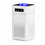 A white rectangular Hilio Aera Air Purifier with a black control panel on the front, perforated ventilation grilles on the sides, and a glowing blue LED light at the top, shown on a plain white background.