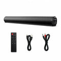 A black cylindrical Hilio Sonora Wireless Soundbar shown with a matching remote control, a USB cable, and an audio cable on a plain white background.