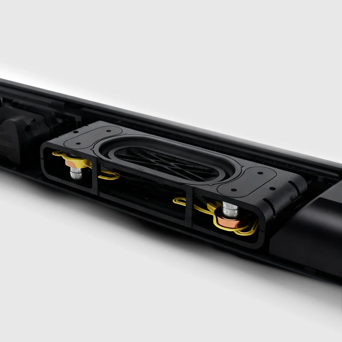 Close-up of a black electronic Hilio Sonora Wireless Soundbar with visible components on a white background