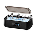 Black JewelyClin Ultrasonic Jewellery Cleaner with items being cleaned inside on a white background