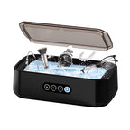 Black JewelyClin Ultrasonic Jewellery Cleaner with items being cleaned inside on a white background