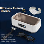 JewelyClin Ultrasonic Jewellery Cleaner with a watch, gold earring, and glasses on a blue background