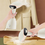 Handheld Krevont Steamer being used on a beige jacket