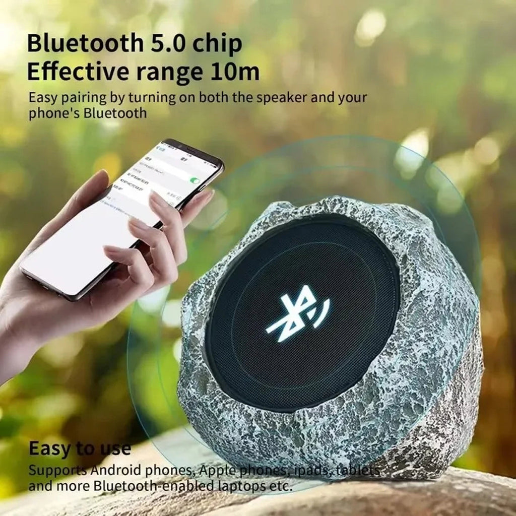 LarnClis Garden Speaker Bluetooth speaker with stone-like texture and person holding phone with Bluetooth icon, outdoors.
