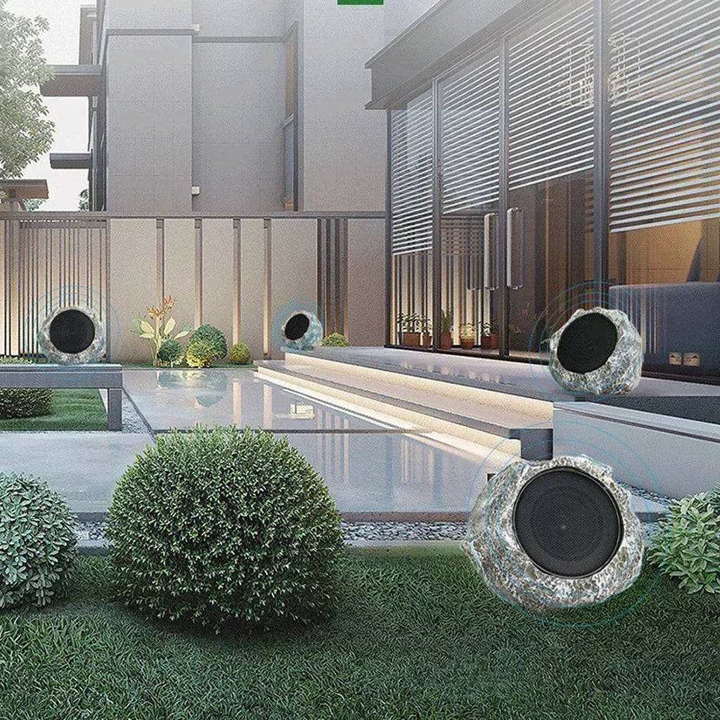 Outdoor garden with modern LarnClis Speaker and a pool area.