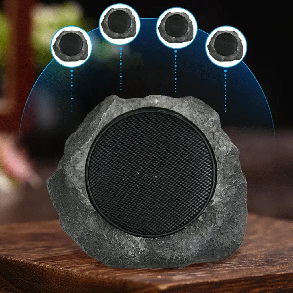 Rock-like speaker with four embedded speakers on a wooden surface