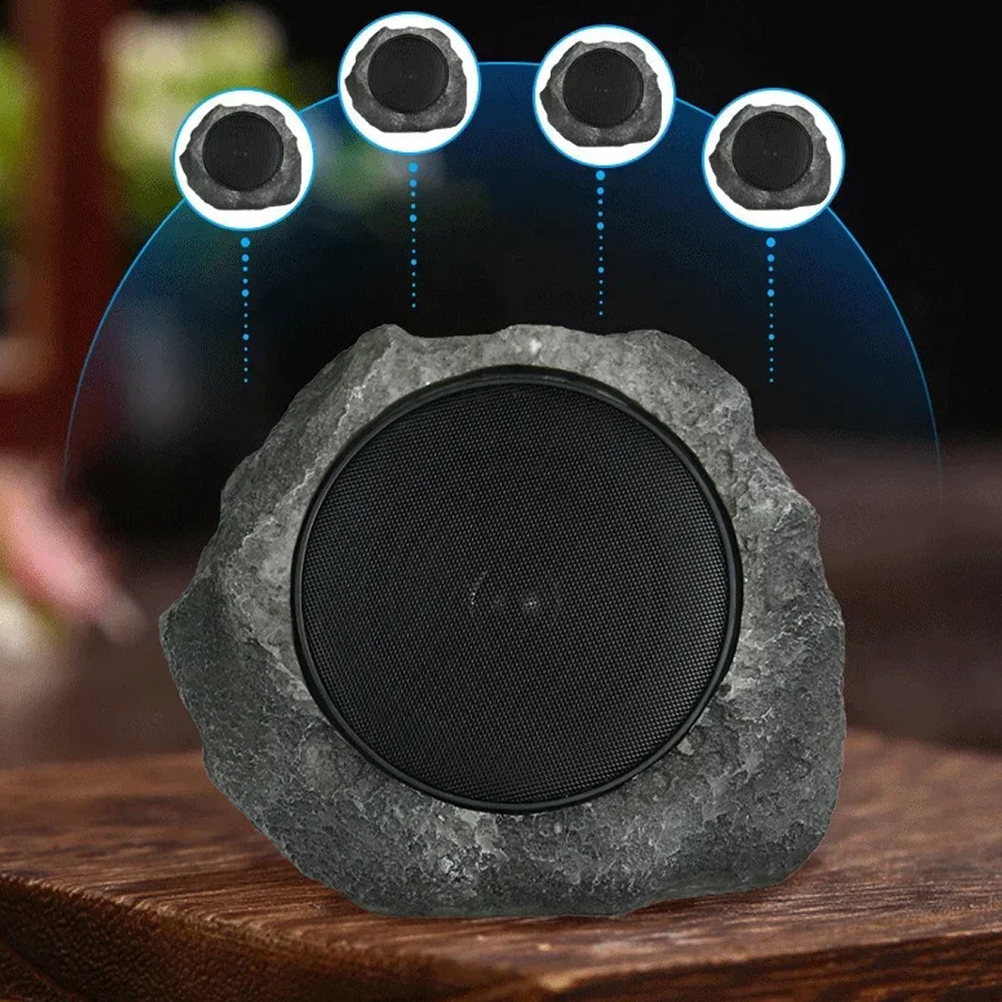 Rock-like speaker with four embedded speakers on a wooden surface
