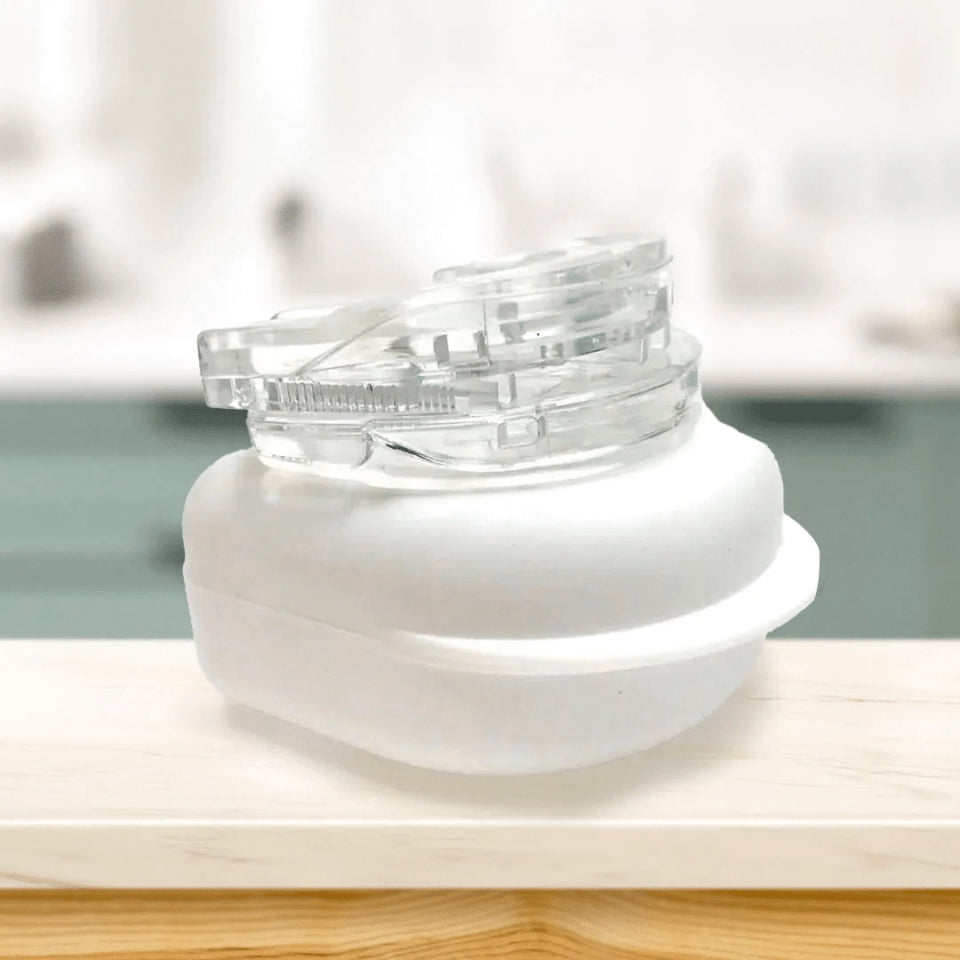 Lullyzee Anti Snore Mouthpiece aligner on a white base with a blurred background