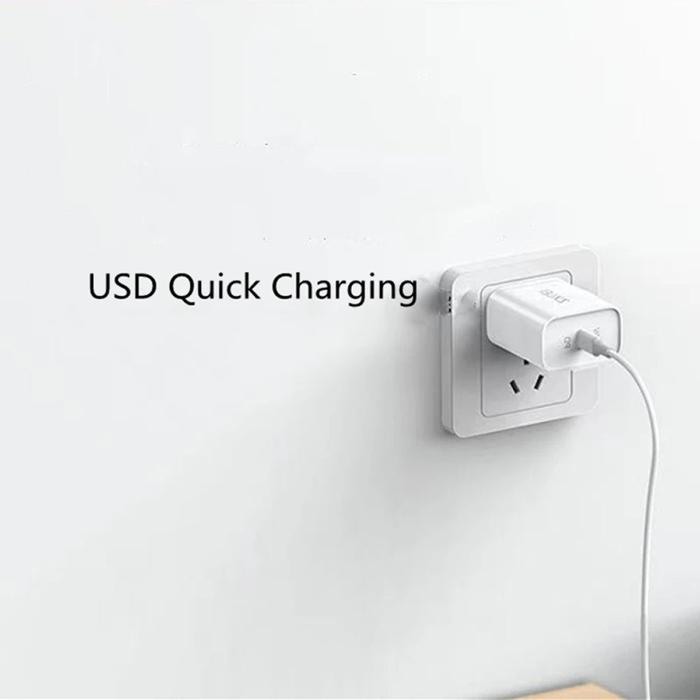 A white USB wall charger plugged into a white wall outlet, with the text 'USB Quick Charging' printed on the left side of the image.