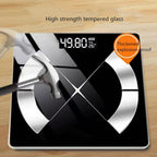 Digital bathroom MillKindy Smart Body Scale with tempered glass surface on a wooden background