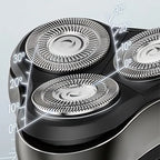 Close-up of a three-head Orivana Electric Shaver with adjustable angles on a light gray background