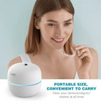 Woman holding a clear OsicClear Ultrasonic Retainer Cleaner with a white container on a light blue background