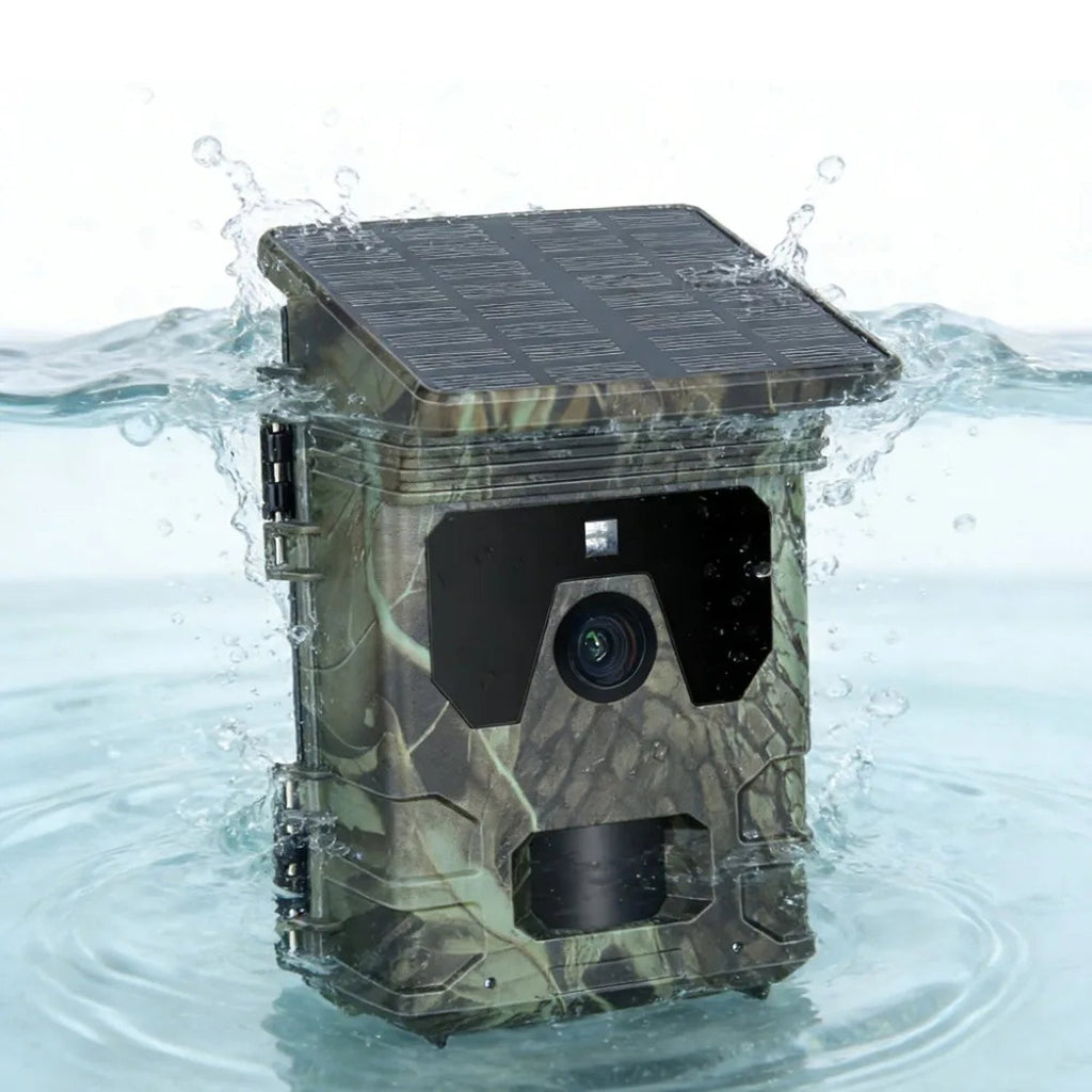 A waterproof PawnixCam Solar Wildlife Camera with a built-in solar panel on top, shown partially submerged in splashing water.