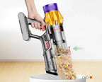 Hand holding a cordless Purco V18 Vacuum Cleaner with a clear container filled with colorful items on a white background.