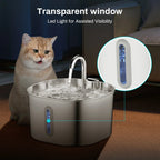 Cat sitting next to a pet water fountain with a transparent window and LED light feature.