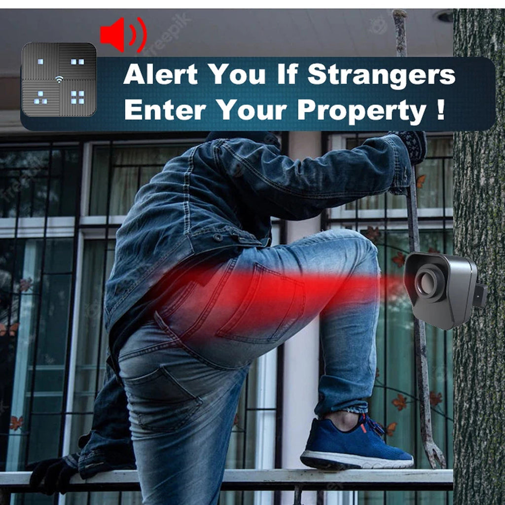 A person in a denim jacket and jeans is shown climbing a tree next to a wall-mounted security camera. A red light beam graphic indicates the camera is detecting motion, and a dark banner at the top reads, 'Alert You If Strangers Enter Your Property!'.