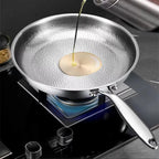 TikaxPan Titanium Frying Pan on a stove with oil being poured onto a pancake.