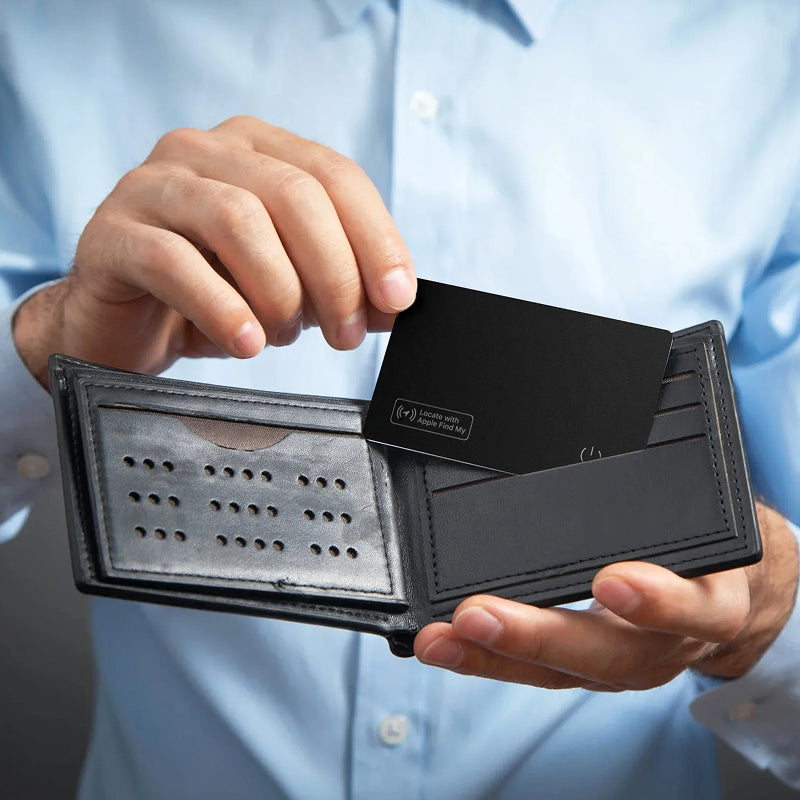 Person holding a black wallet with a Tiverno Apple MFi Certified Wallet Tracker Card inside, wearing a light blue shirt.