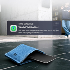 Blue wallet with a digital notification on a wet pavement