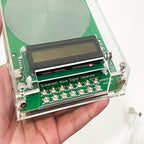Schumann Wave VanotCine Frequency Generator held in a hand with a white background