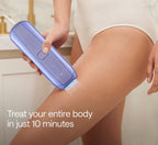 Person using a purple Veliss Pro 10S IPL Hair Removal Device on their leg with text 'Treat your entire body in just 10 minutes' in a kitchen setting.