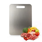 Wavel Titanium Cutting Board with fresh produce and meats on a white background
