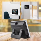 Zephytrak Home Weather Station temperature display on a wall with a tablet stand on a wooden surface.