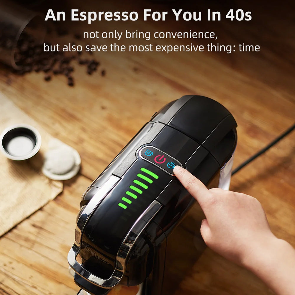 Hand holding a portable brewnexi coffee machine on a wooden surface with coffee beans and a cup of coffee.