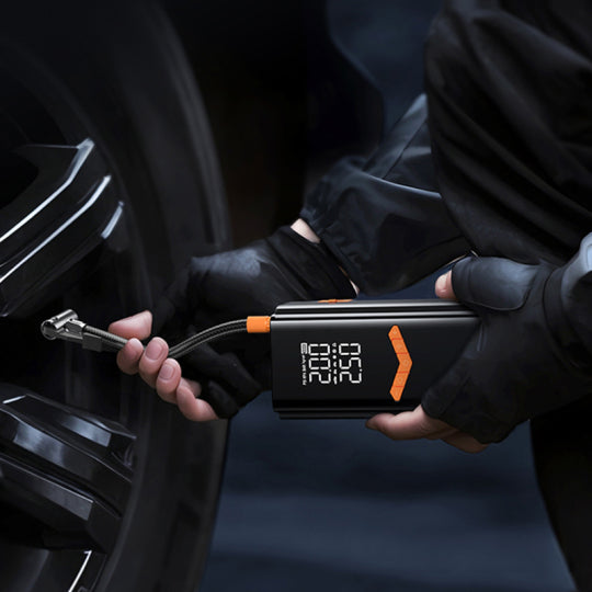 Person using a digital Mektri 2 in 1 Jump Starter & Tyre Inflator on a car tire